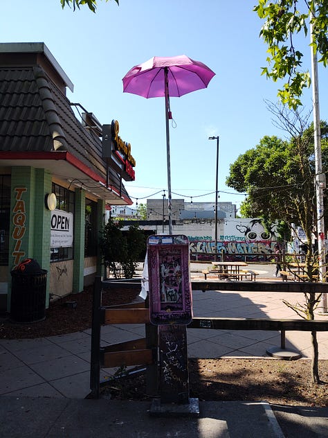 A pink umbrella atop a defunct telephone booth outside the taco spot on 10th & Pine; protesters gather at Cal Anderson on June 20; a sign painted with dedications to Anderson (aka Lil Mob)