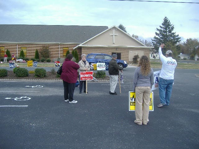 Discussing issues with a voter. Discussing issues with a voter.