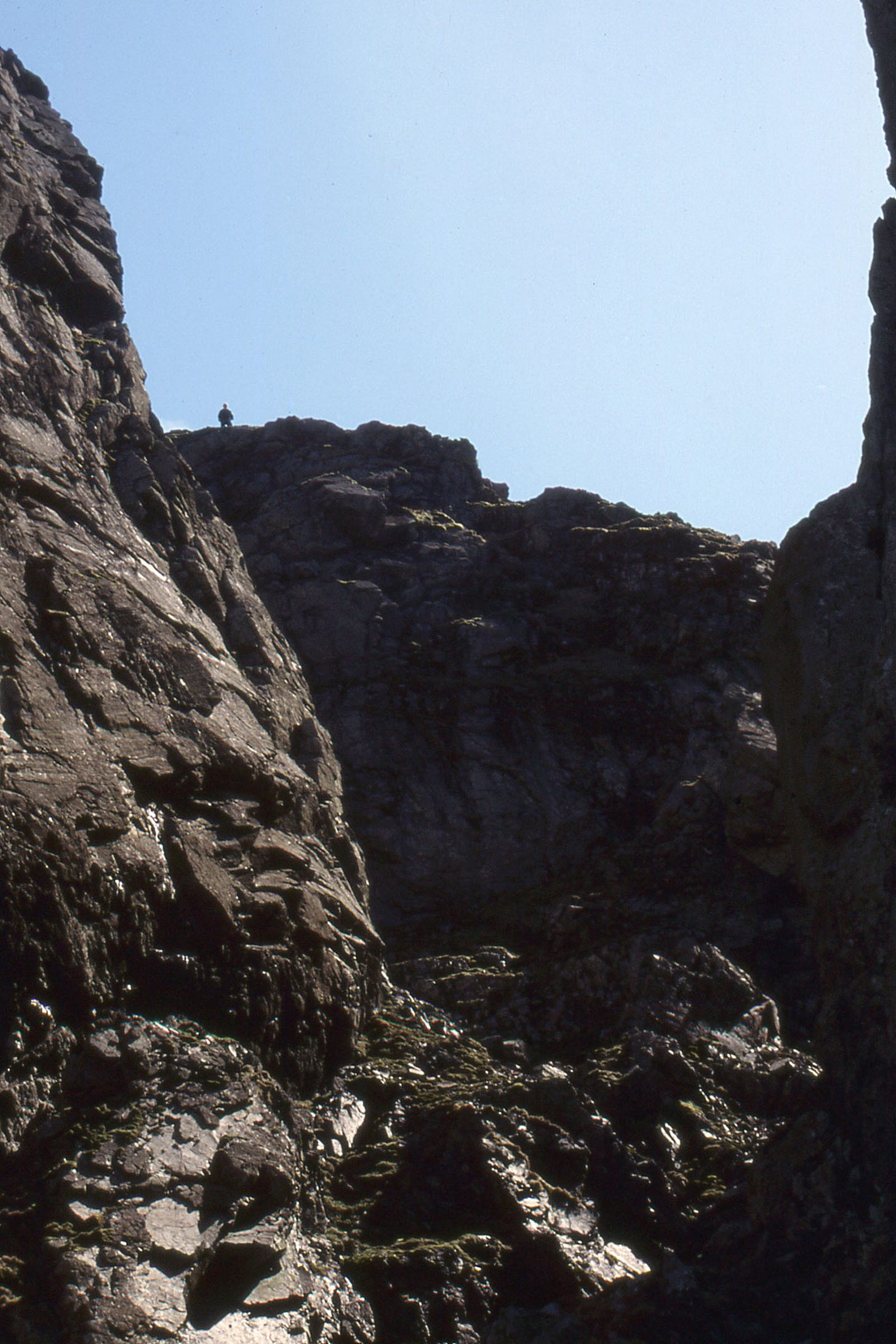 crags and chasms, solitary walker on skyline