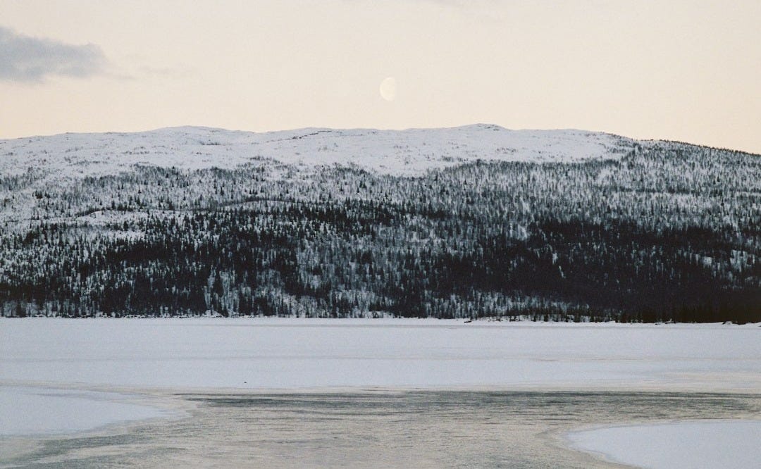 body of water beside mountain