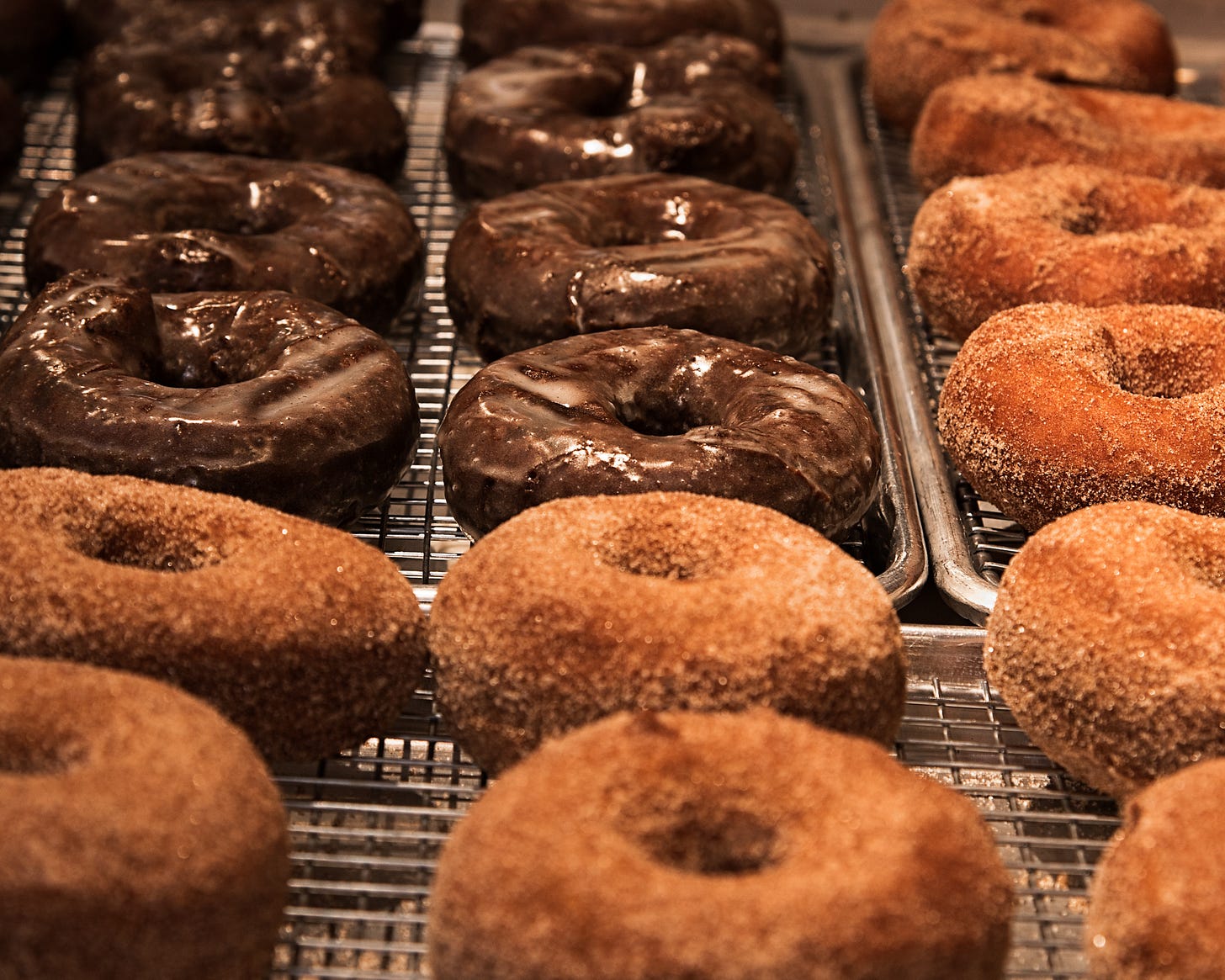 Racks of doughnuts. Chocolate and cinnamon sugar. Mmmm.