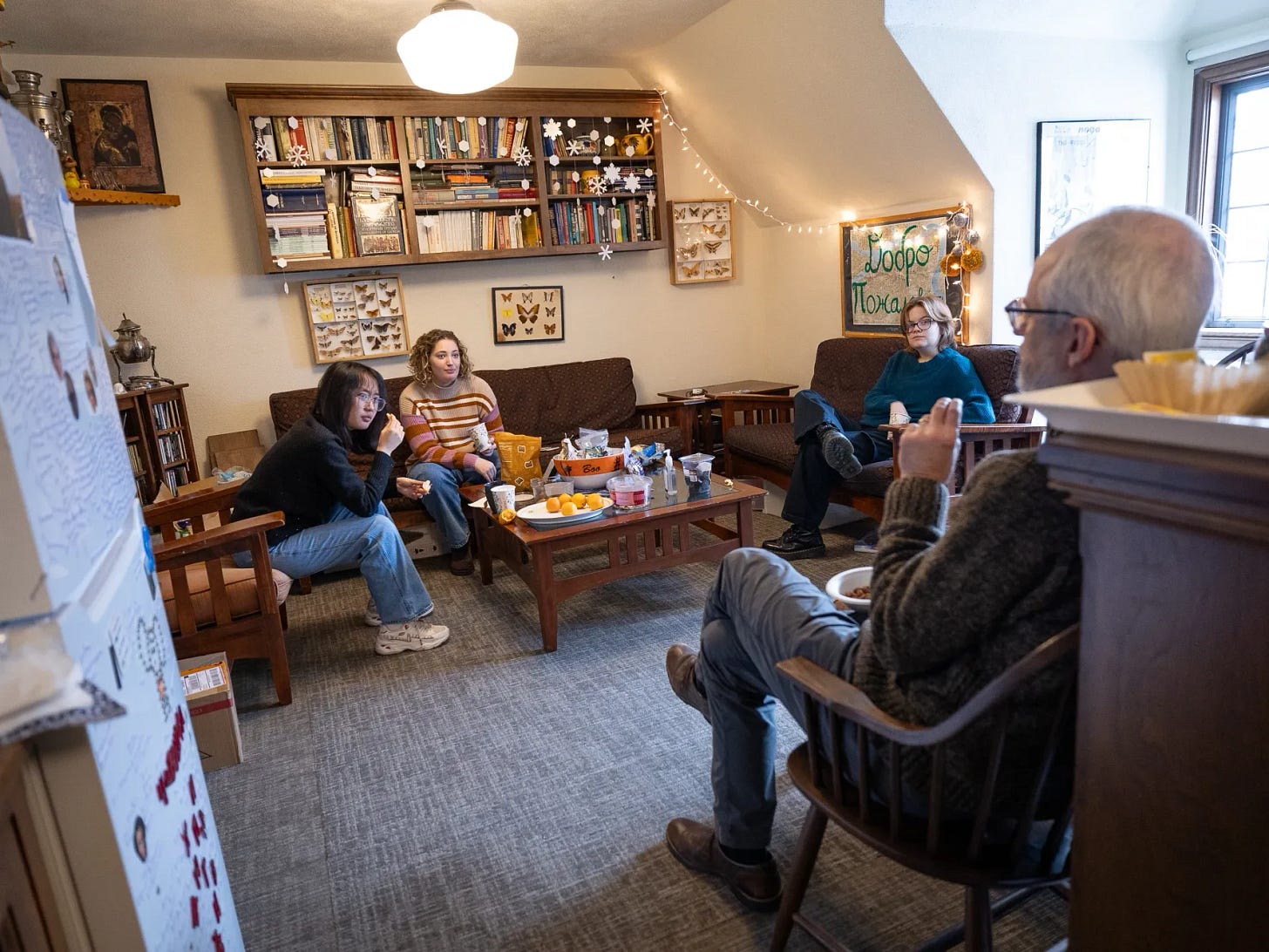 Three students listen to a professor speaking in the Wellesley Russian department lounge. Three students listen to a professor speaking in the Wellesley Russian department lounge.