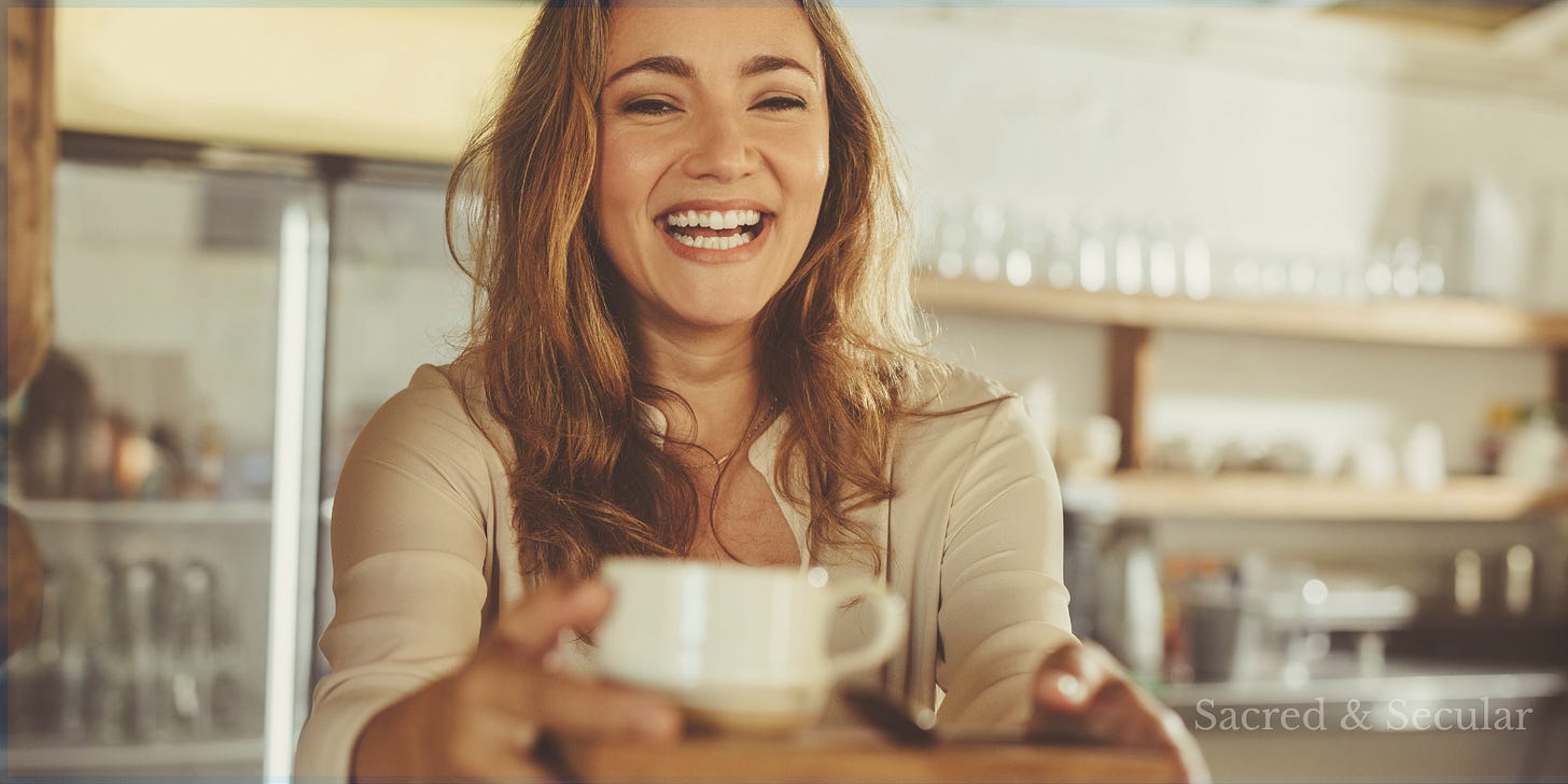 Smiling woman in a warmly lit café offering a cup of tea or coffee across a table, symbolising hospitality, welcome, and simple acts of kindness. Smiling woman in a warmly lit café offering a cup of tea or coffee across a table, symbolising hospitality, welcome, and simple acts of kindness.