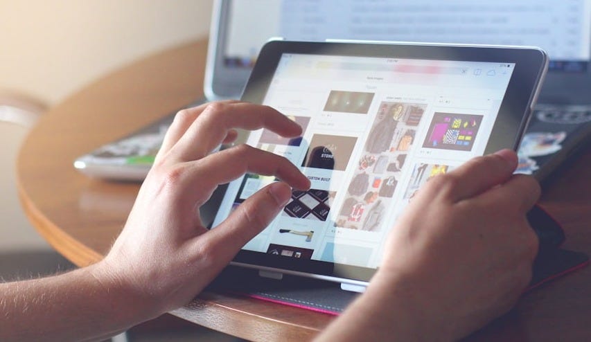 person holding black iPad person holding black iPad