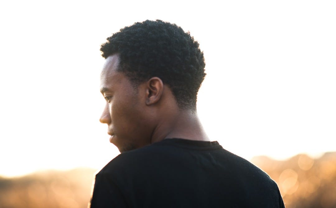 man wearing black crew-neck t-shirt
