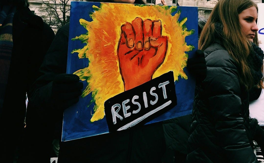 woman holding resist signage