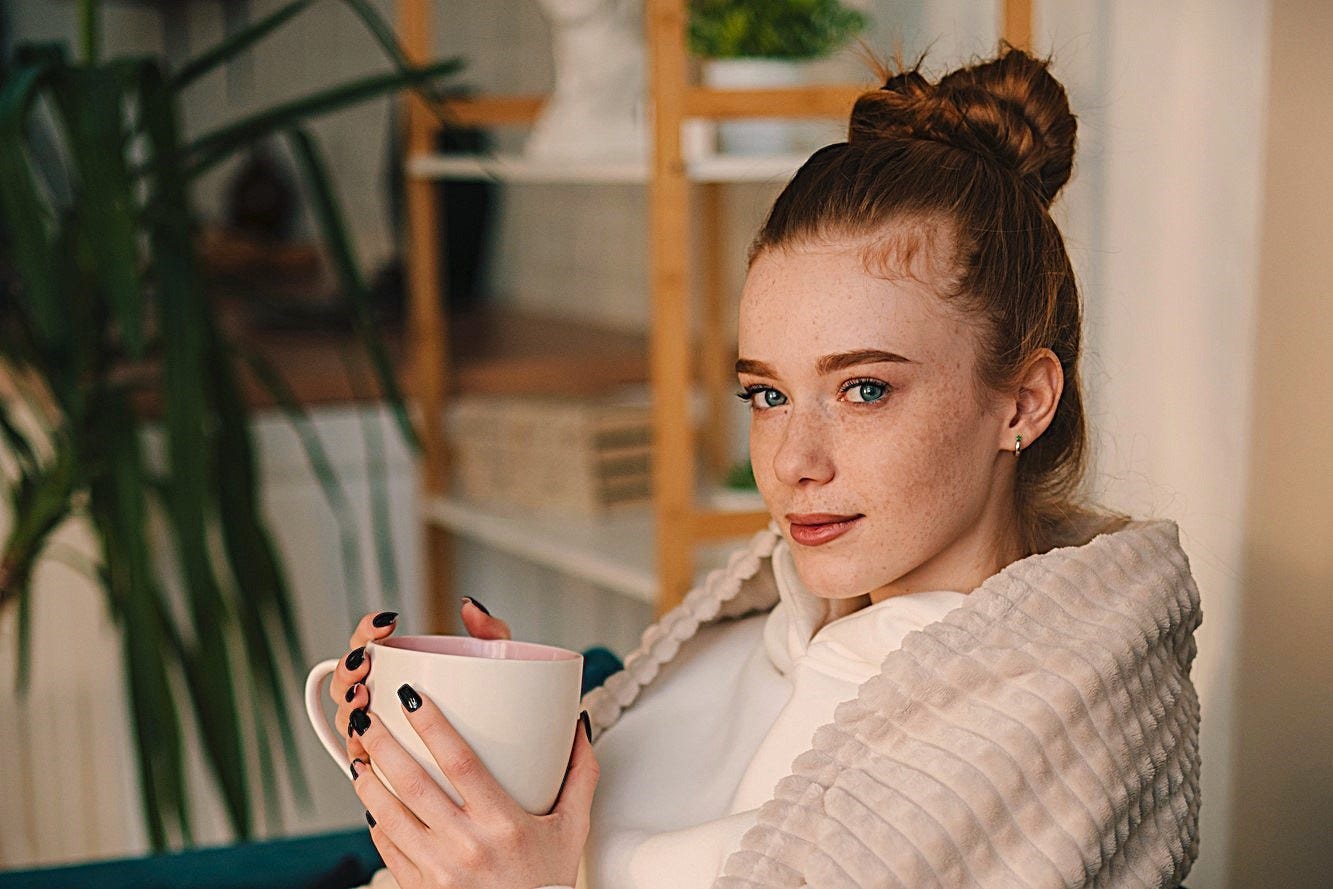 A pretty young woman with red hair and freckles