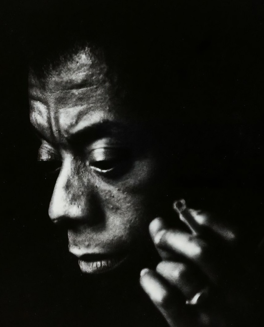 a black and white photo of a man talking on a cell phone