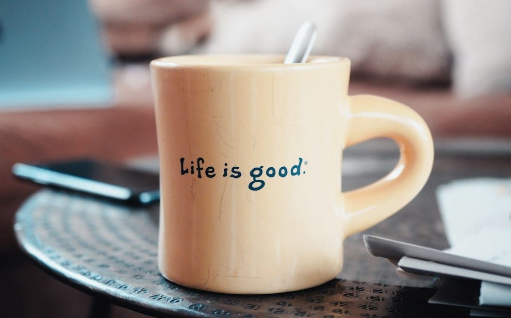 brown ceramic mug on blue and white ceramic plate