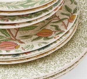 fabric swatches, living room set design, vintage plates stacked up with matching colours