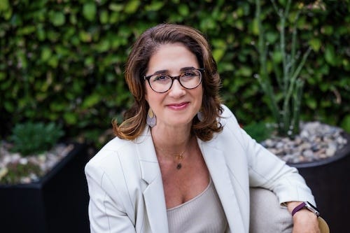 blair glaser in glasses smiling outdoors wearing light grey jacket and shirt blair glaser in glasses smiling outdoors wearing light grey jacket and shirt