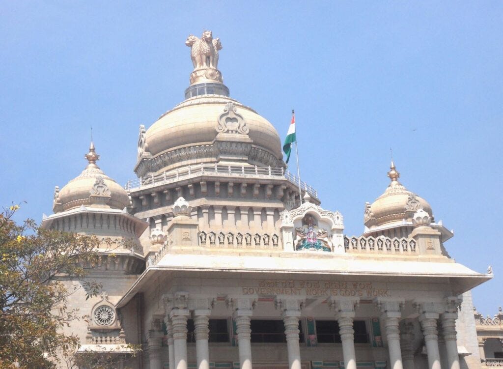 Karnataka State Legislative Assembly is inscribed: "Government Work is God's Work" - sceptical 
