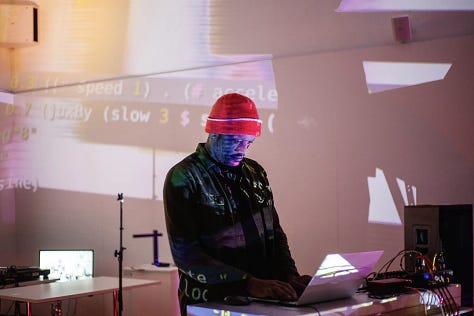 Images of artists working with computers and projectors in an art gallery