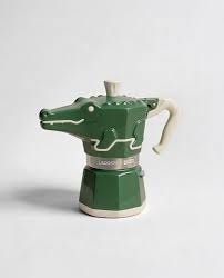 A conceptual Lacoste × Bialetti collaboration created by @jane_morelli,  reinterpreting the iconic Moka Express through the lens of classic tennis  heritage. Court-inspired colors and restrained branding meet the familiar  octagonal form, linking