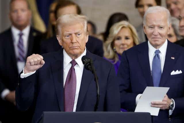 Donald Trump acknowledging the crowd following his inauguration with Joe Biden looking on. Donald Trump acknowledging the crowd following his inauguration with Joe Biden looking on.