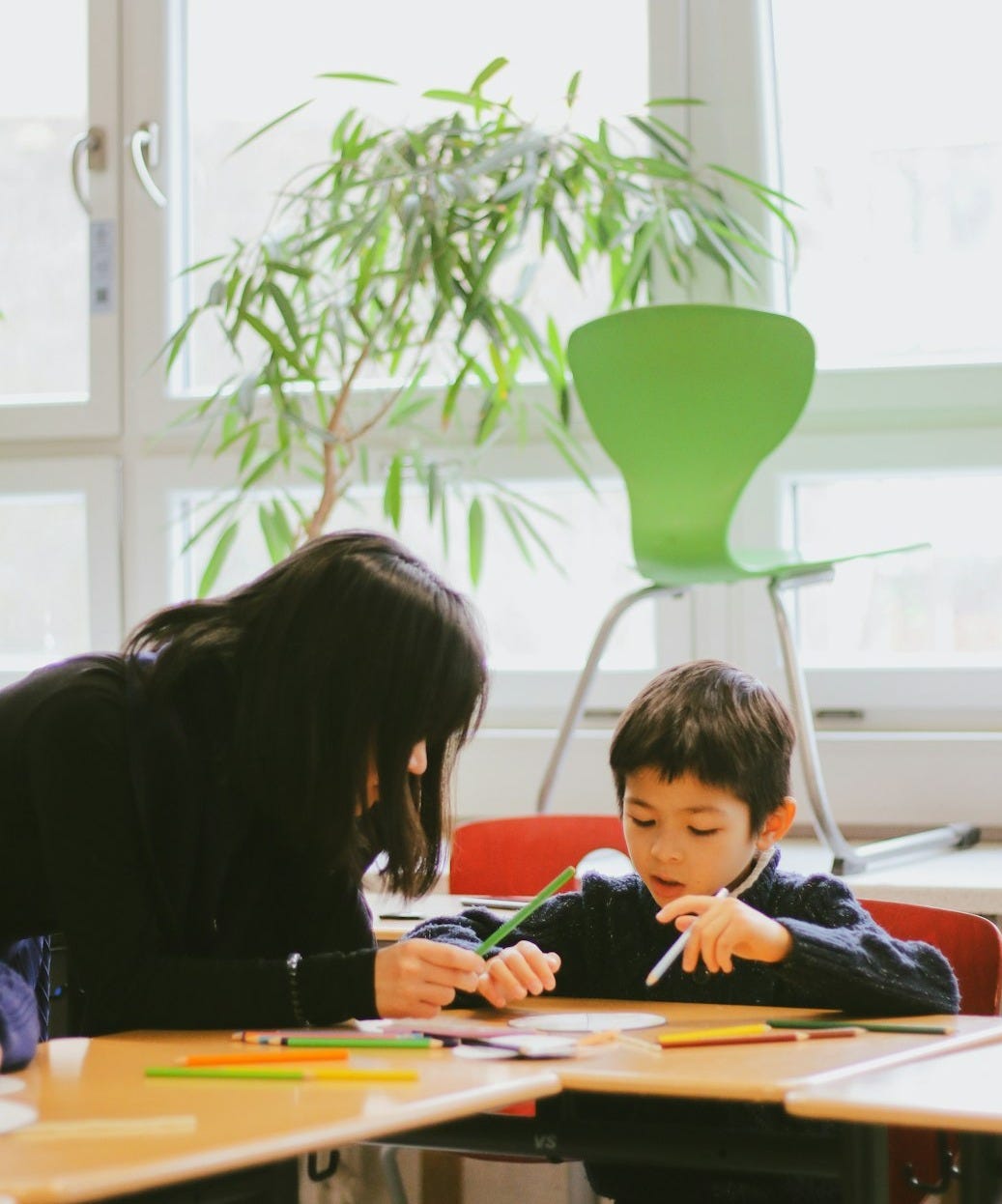 a woman and a child sitting at a table