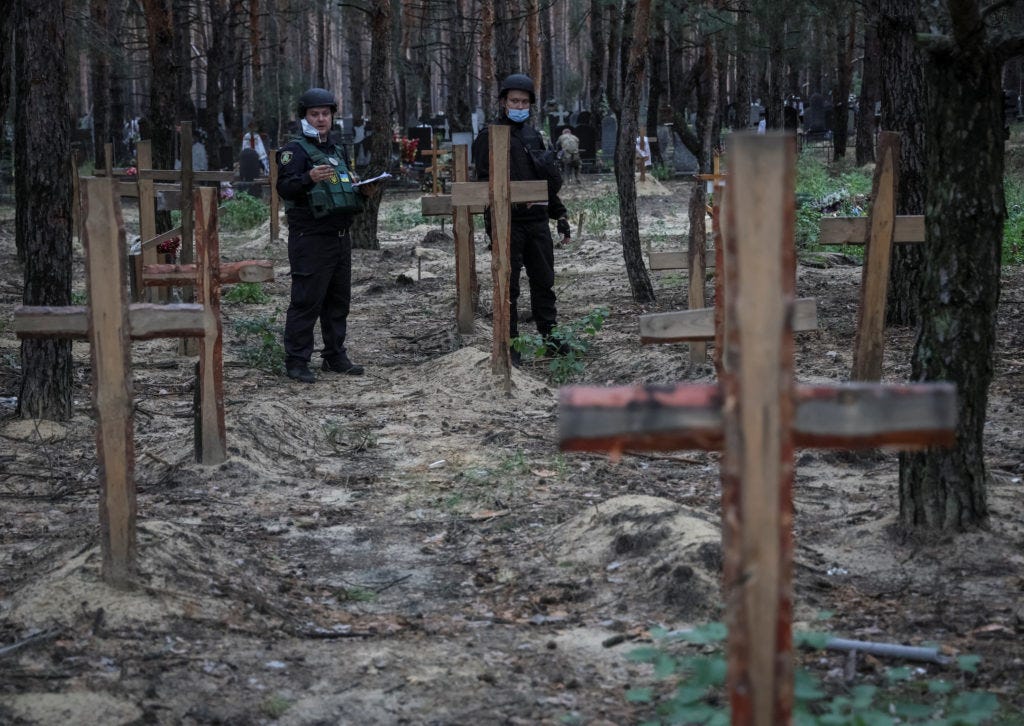 Ukraine examines bodies from mass graves discovered after regaining  territory from Russia | PBS NewsHour