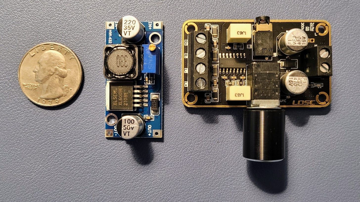 Quarter for scale, buck booster (middle), PAM8406 board (right)