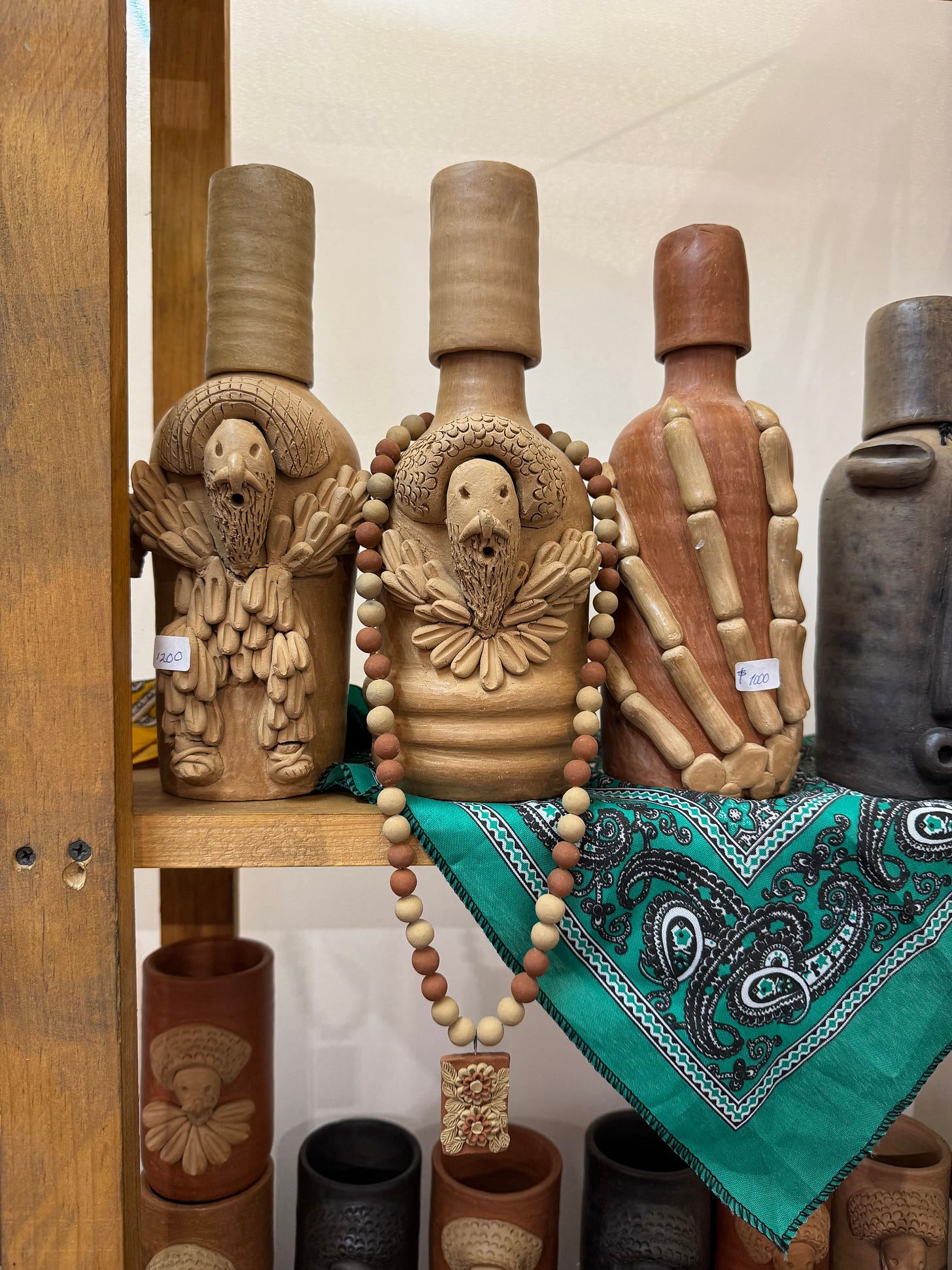 Clay bottles for mezcal with designs.
