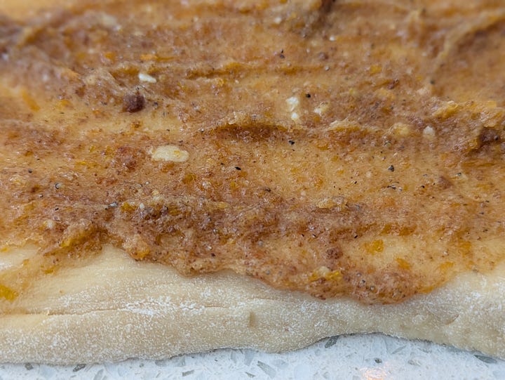 Finished cardamom buns. Gooey cardamom filling on dough.