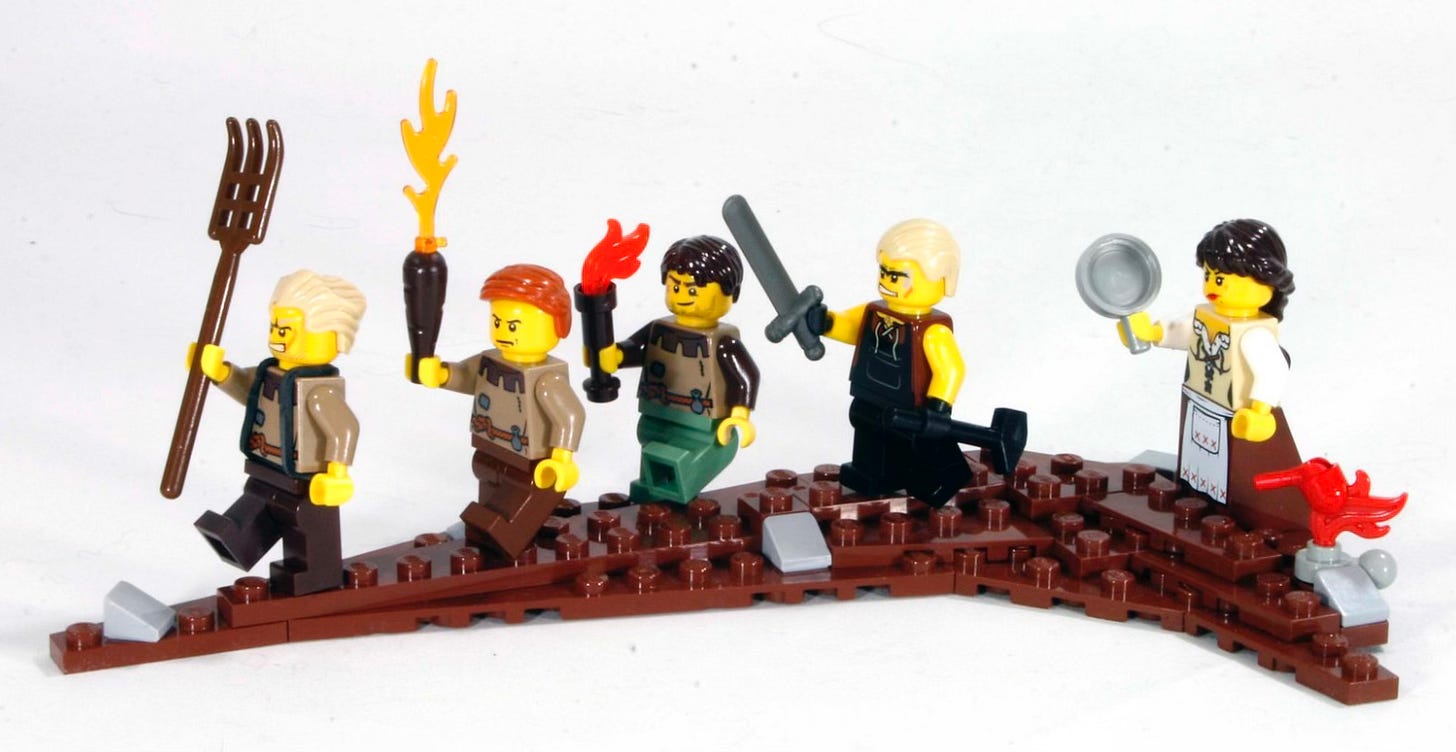 An image of lego figures holding torches and pitchforks