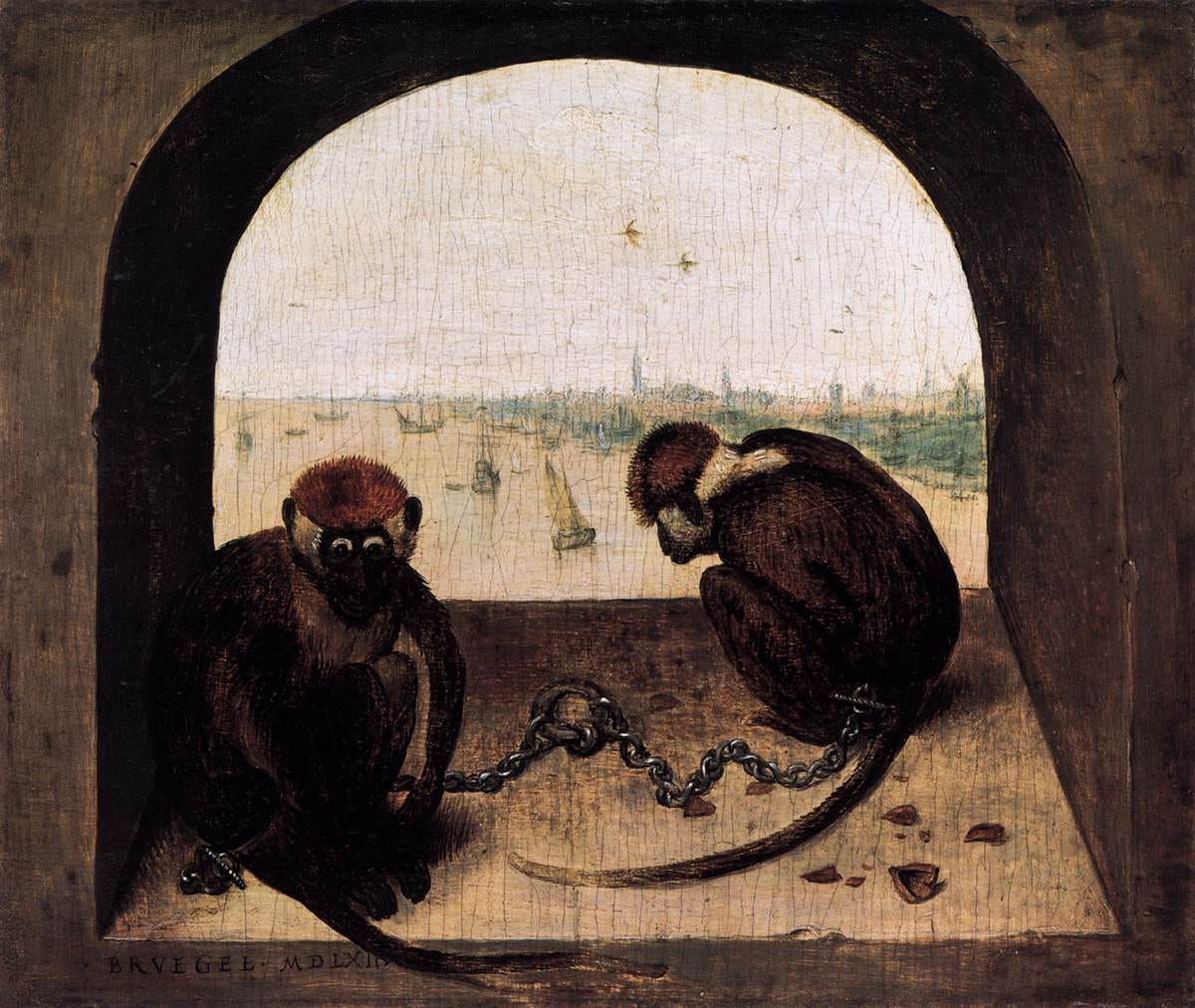 Two chained monkeys in a stone window Two chained monkeys in a stone window