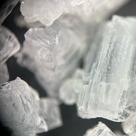 close up images of salt crystals on a black background
