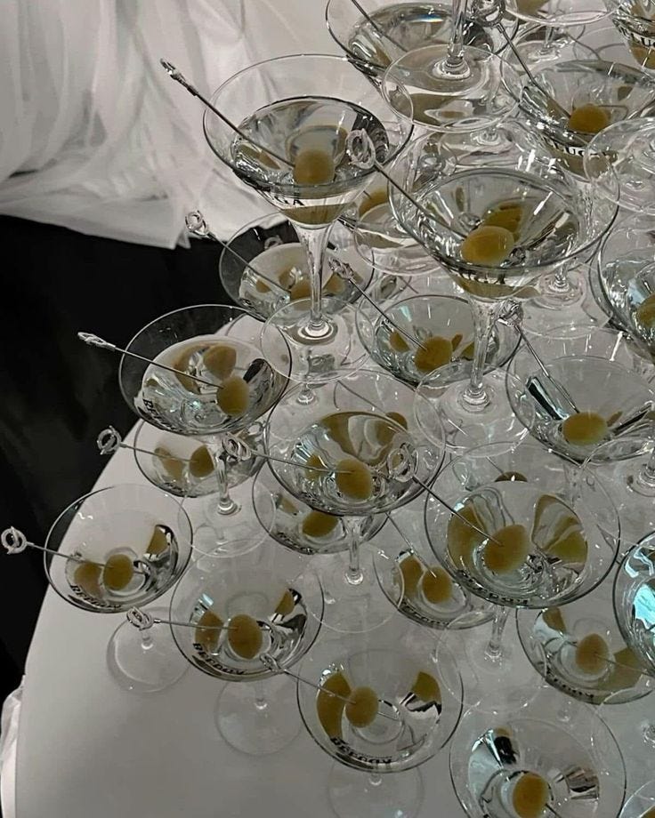 This may contain: there are many glasses on the table ready to be filled with drinks and desserts