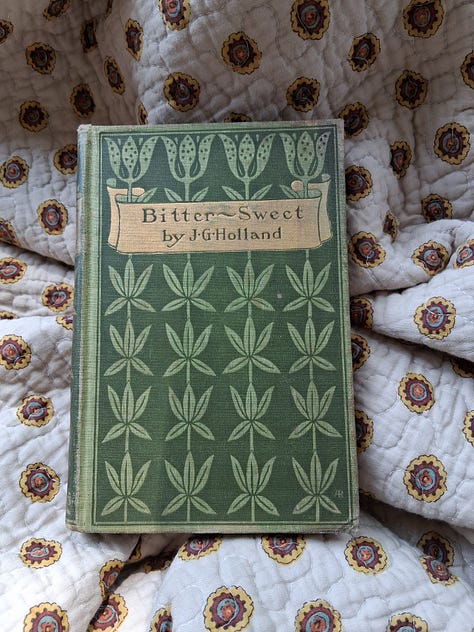 A spread of vintage books opened to reveal pressed four leaf clovers