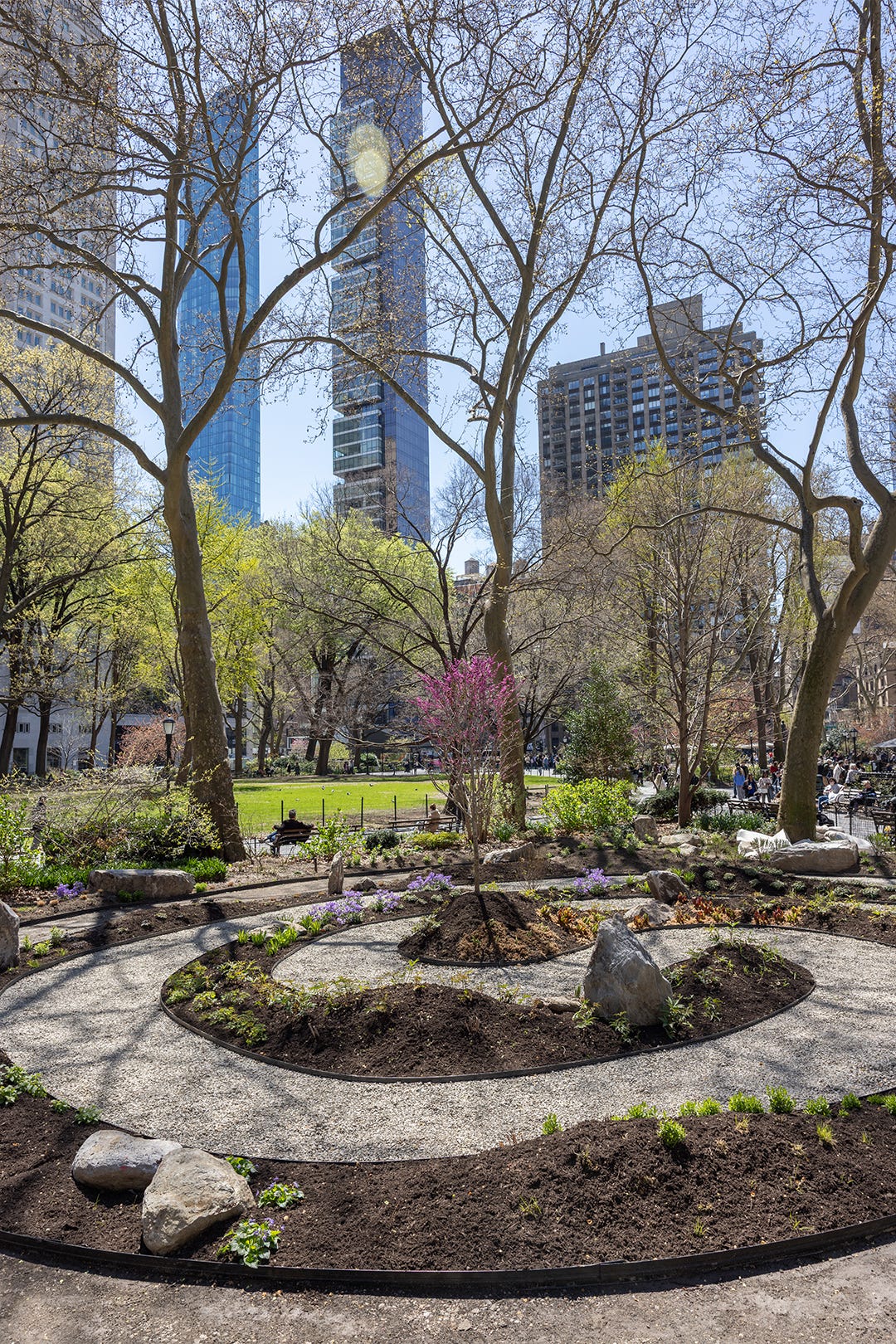 A park with a garden in the shape of a swirl