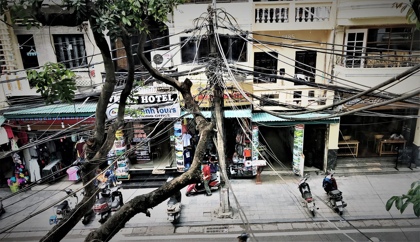 Tangle of utility wires over city street