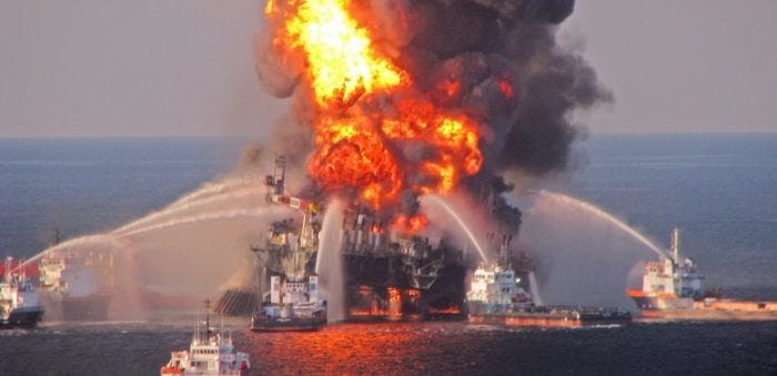 A photo of fireships spraying water at a fire engulfing an oil platform. This is Deepwater Horizon.