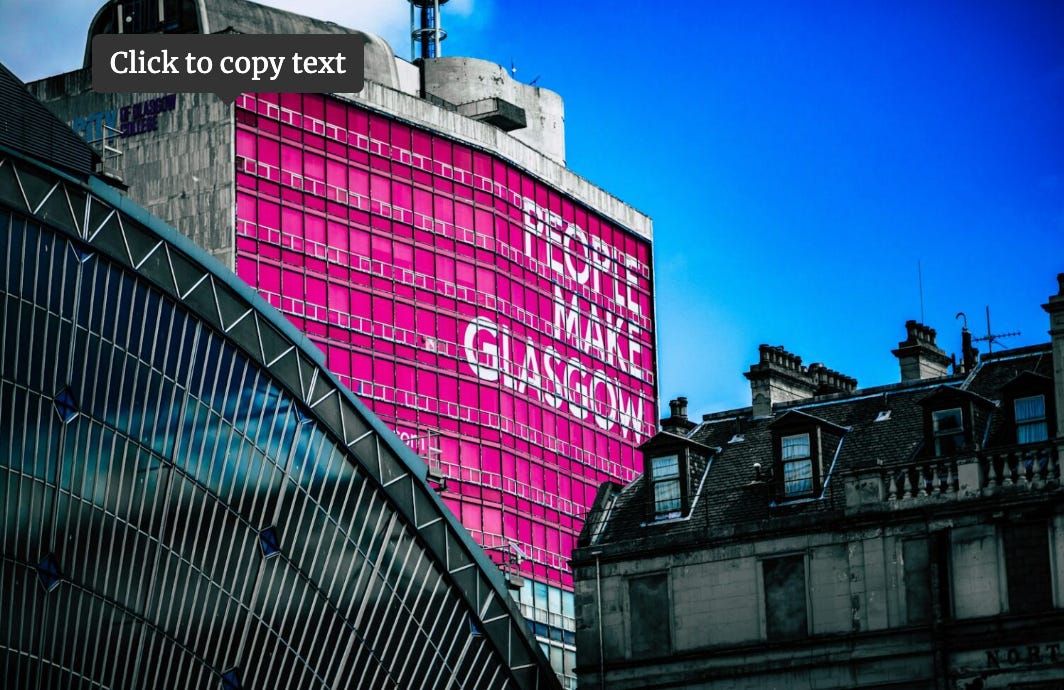 Photo with a building saying 'People Make Glasgow'