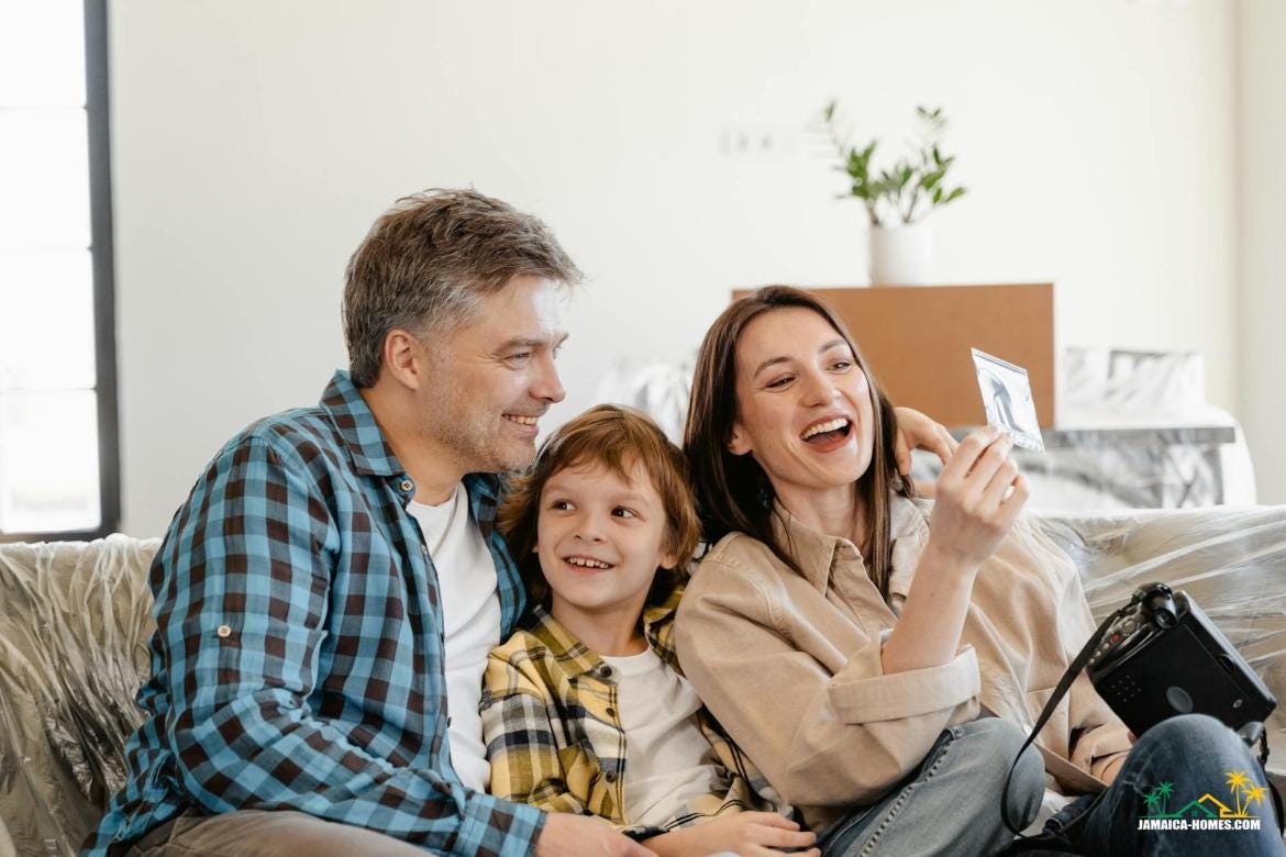 man and woman smiling while holding white smartphone