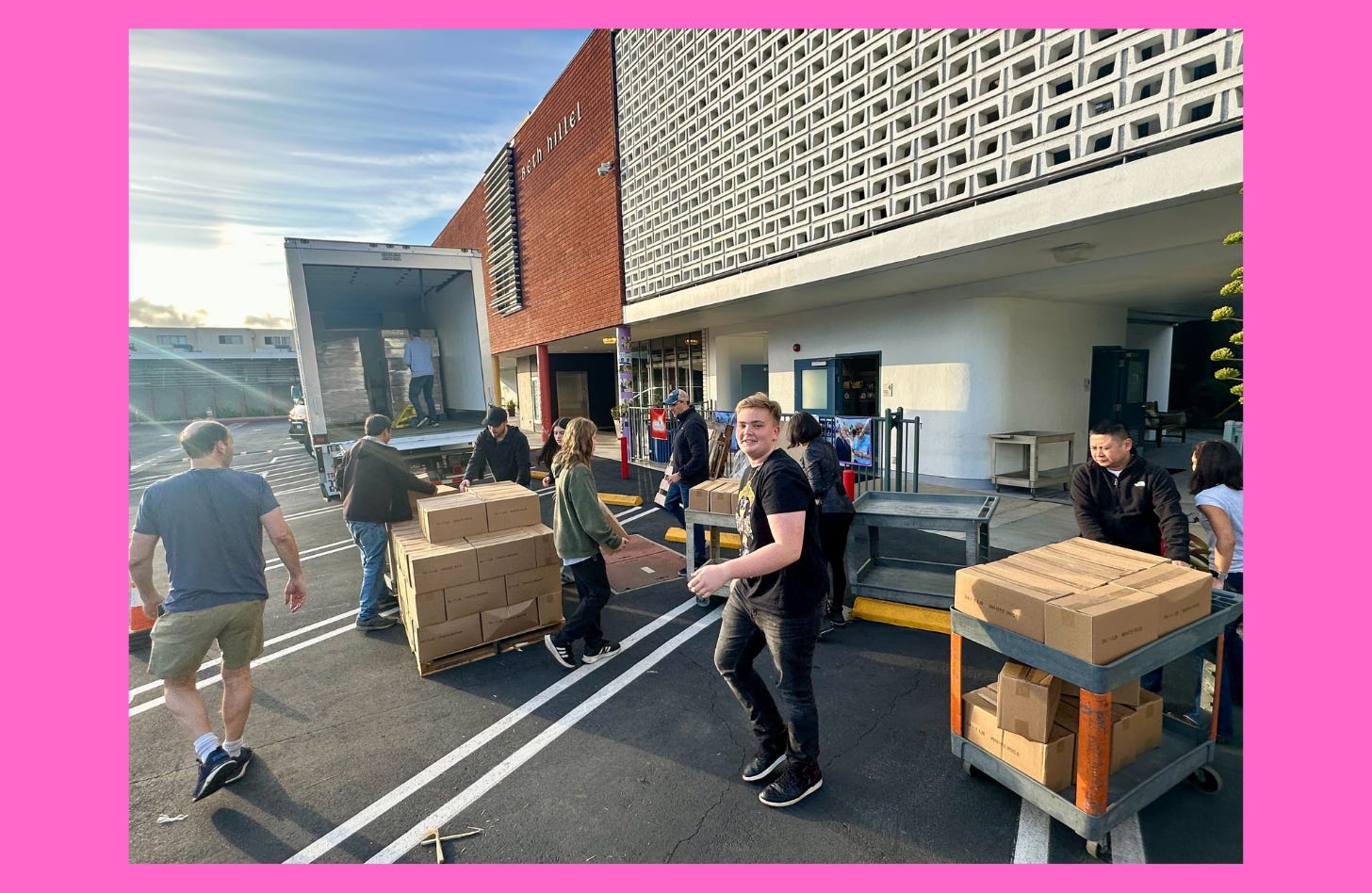 Photo of volunteers unloading a truck outside of the North Hollywood Interfaith Food Pantry.