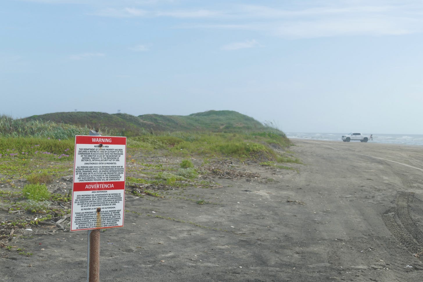 DoD restricted area marker on beach DoD restricted area marker on beach