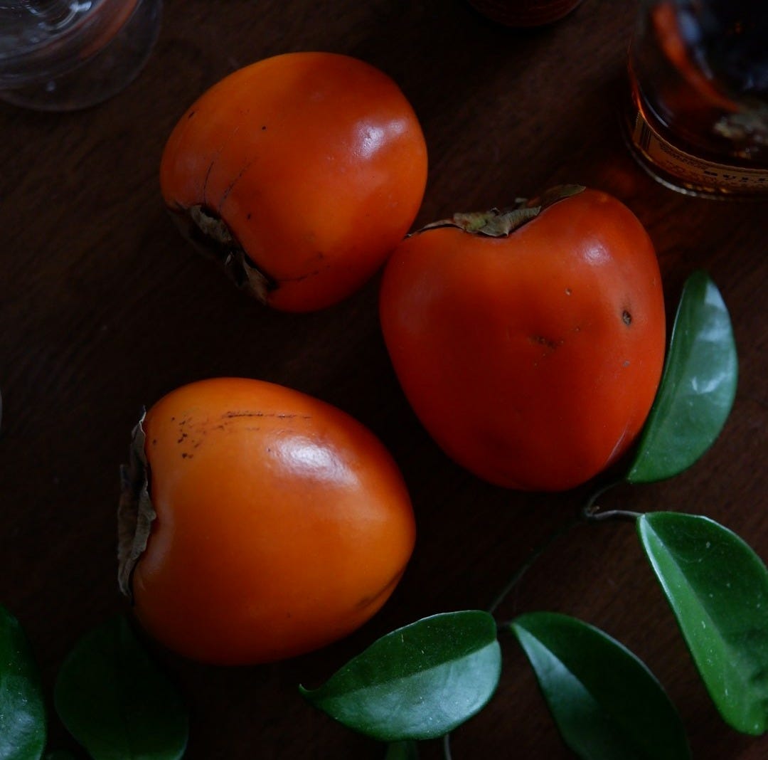 orange tomato on brown wooden table