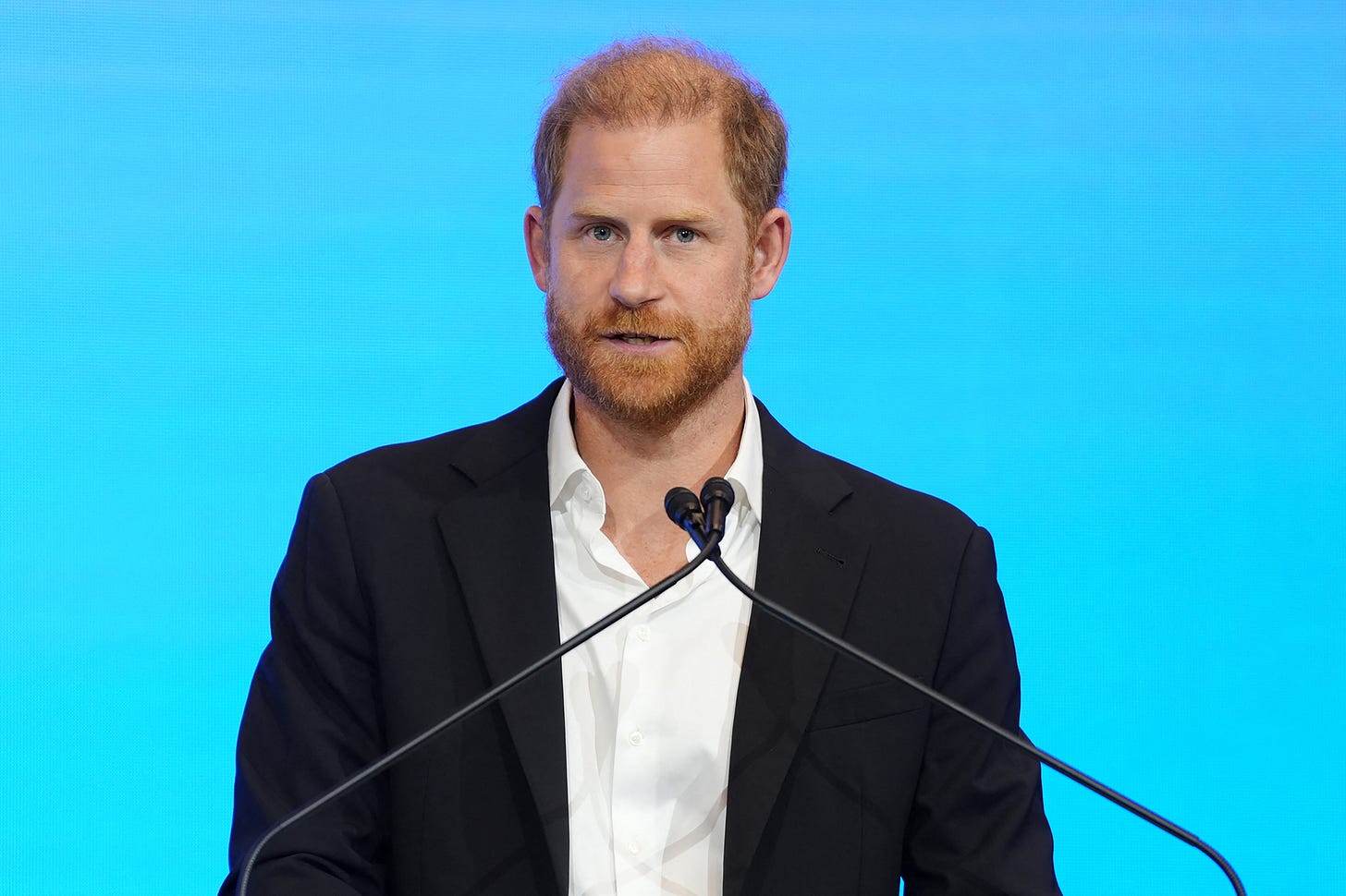 Prince Harry speaks at a podium