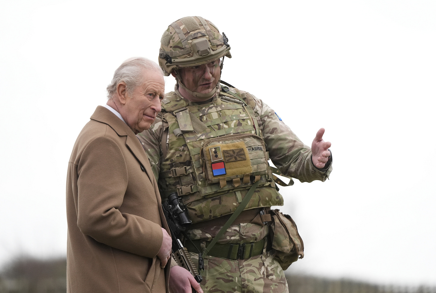 King Charles looking at something stood next to an army soldier King Charles looking at something stood next to an army soldier