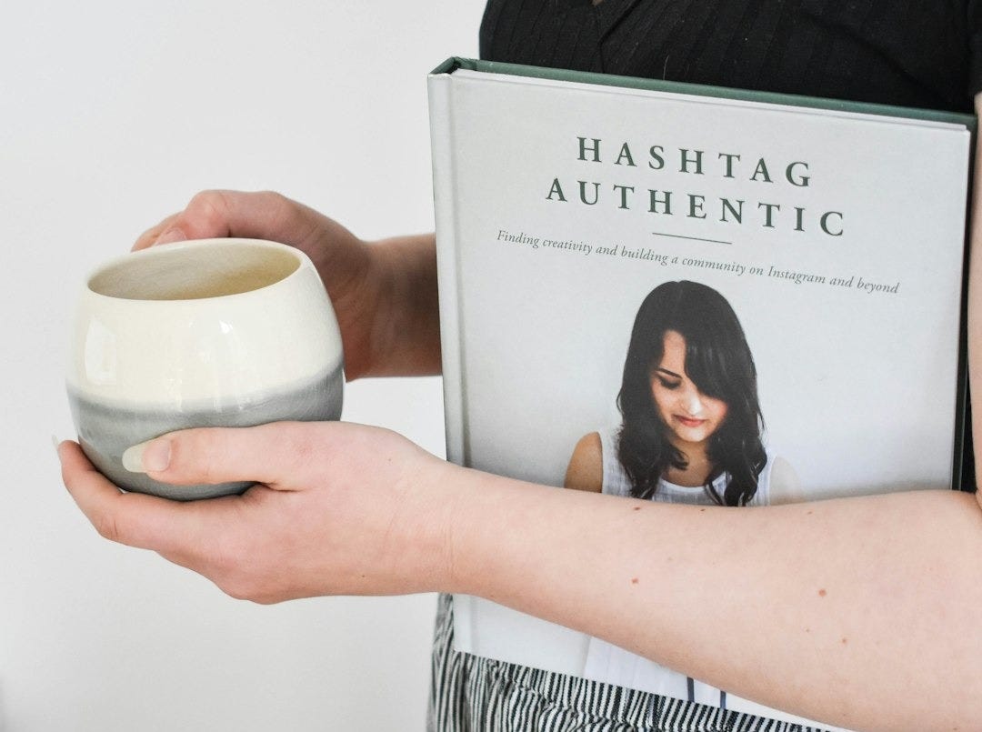 a woman holding a book and a bowl