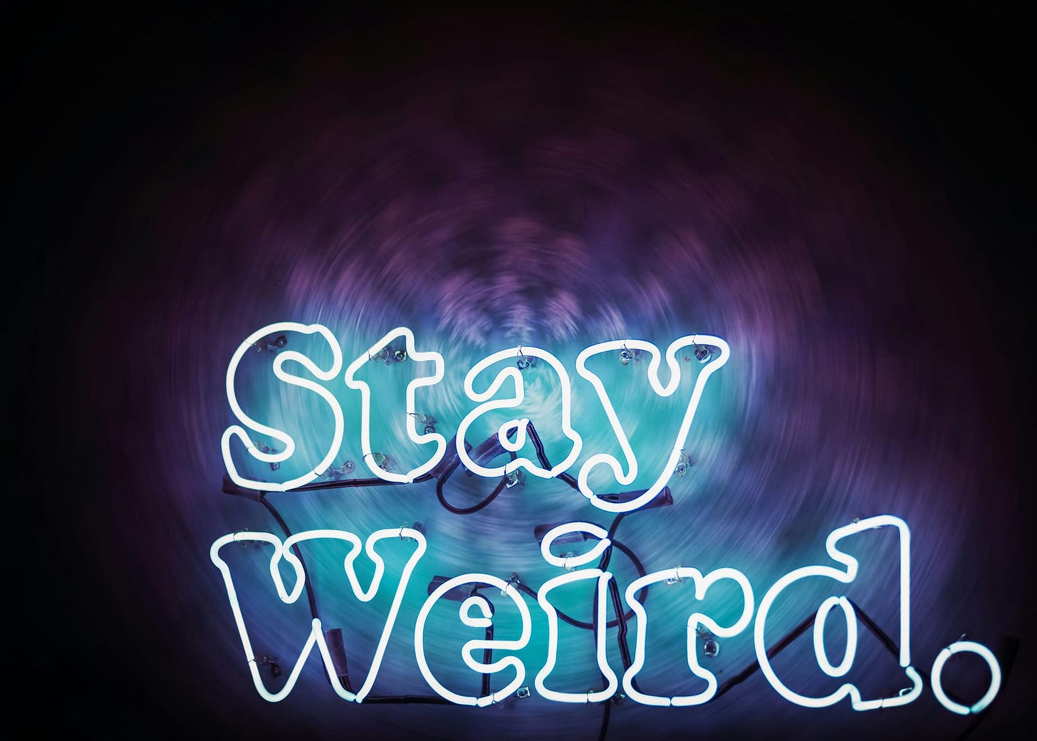 Neon sign stating "Stay Weird." Neon sign stating "Stay Weird."