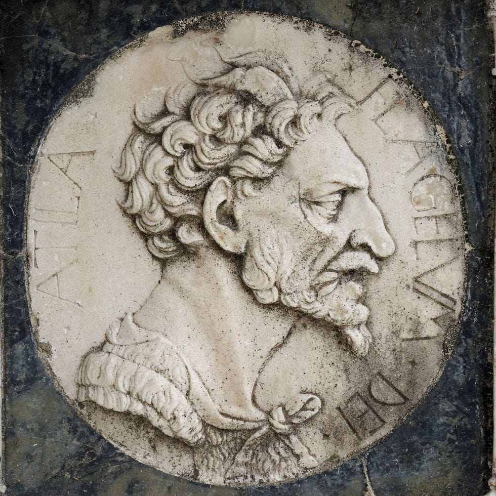 large engraving of a man in profile looking right, he has curly hair and a curly beard