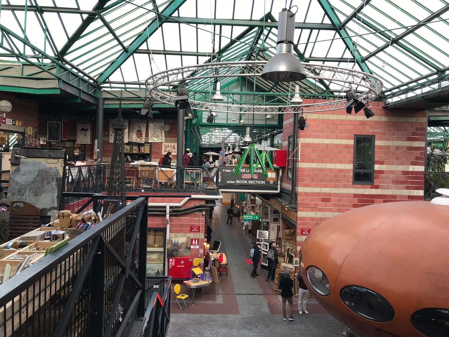  Second floor overview of Jules Valles Market with its orangerie type glass and iron dome at Paris Saint Ouen Flea Market 