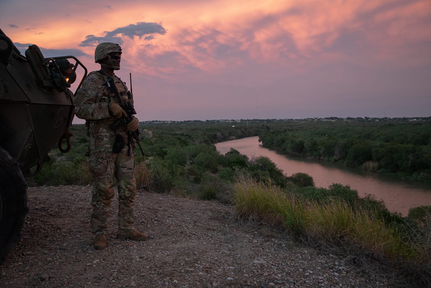 Soldier masked stands over the Rio Grande. (U.S. Army photo by Pfc. Sean Hoch) 