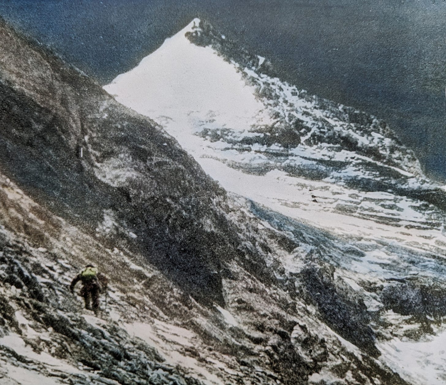 Snow pyramid: slope of rock and scree; climber with iceaxe