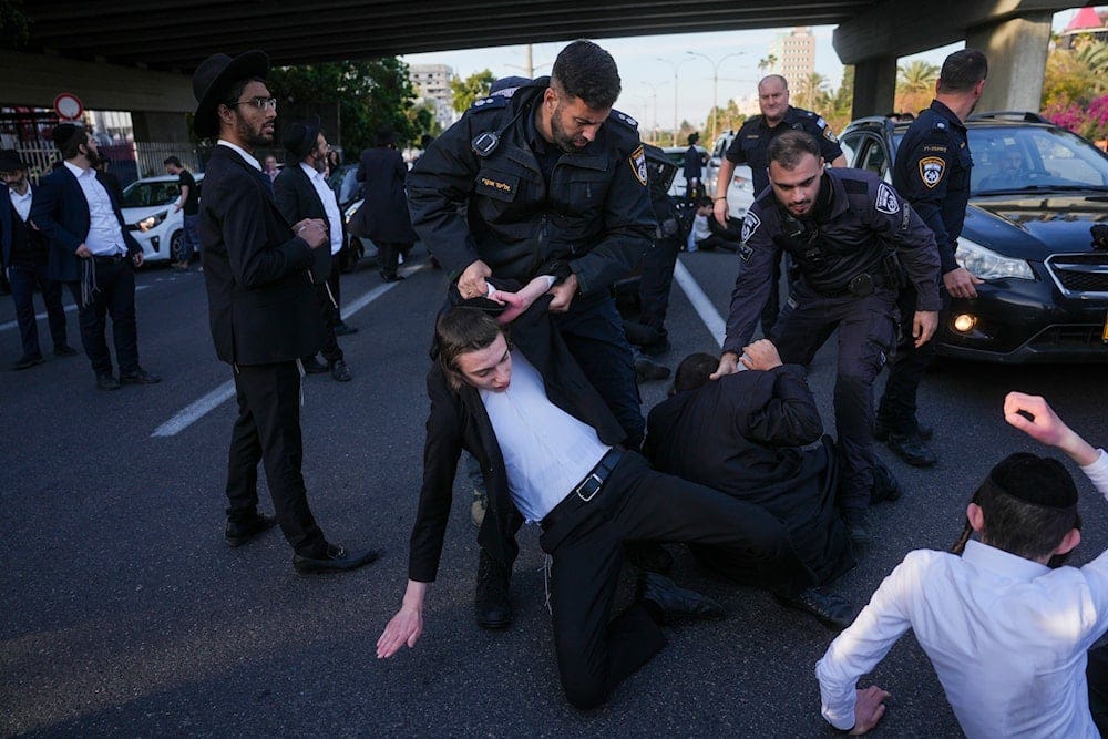 Israeli police officers attack Ultra-Orthodox Jewish men during a protest against army recruitment in Bnei Brak, Sunday, March 2, 2025. (AP) Israeli police officers attack Ultra-Orthodox Jewish men during a protest against army recruitment in Bnei Brak, Sunday, March 2, 2025. (AP)