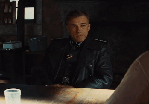 a man in a leather jacket is sitting at a table a man in a leather jacket is sitting at a table
