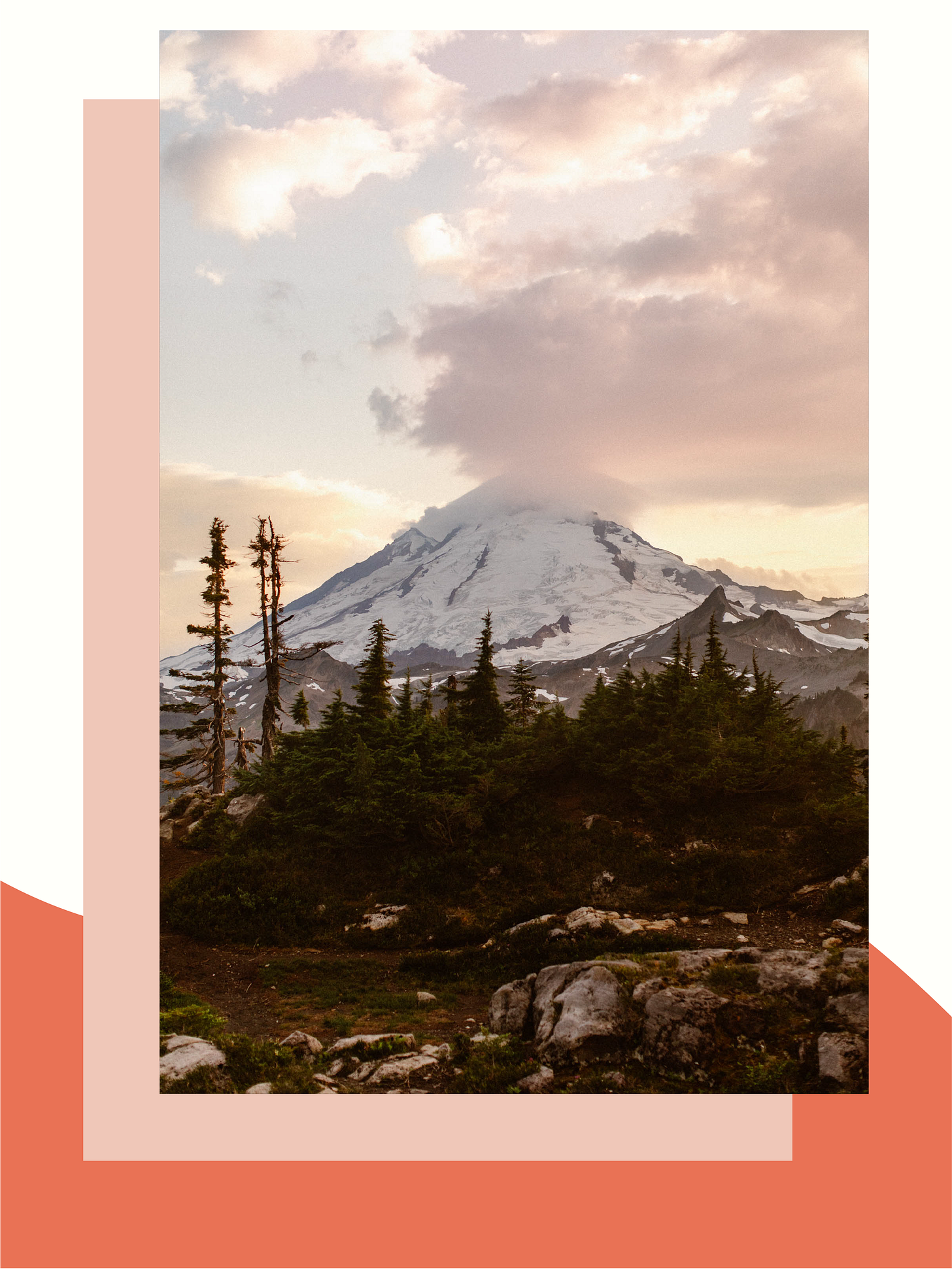 pink-tinged clouds over a snow capped mountain at sunset