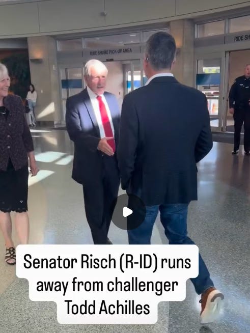 Screenshot of a video posted by Todd Achilles, showing Sen. Jim Risch shaking his hand, with the caption "Senator Risch (R-ID) runs away from challenger Todd Achilles"
