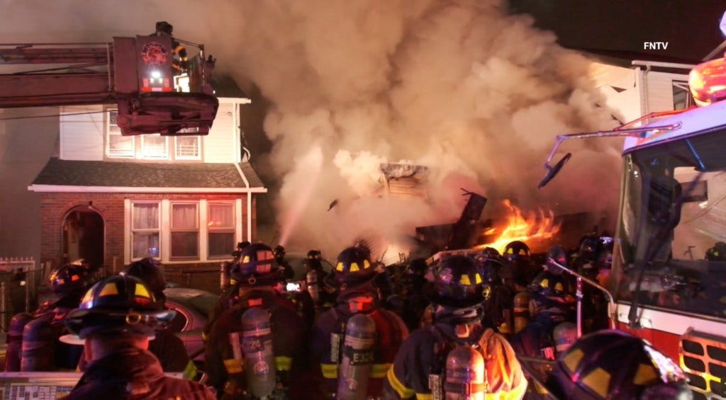 Firefighters battle a five-alarm blaze that destroyed a home at 107-55 130th St in Ozone Park.